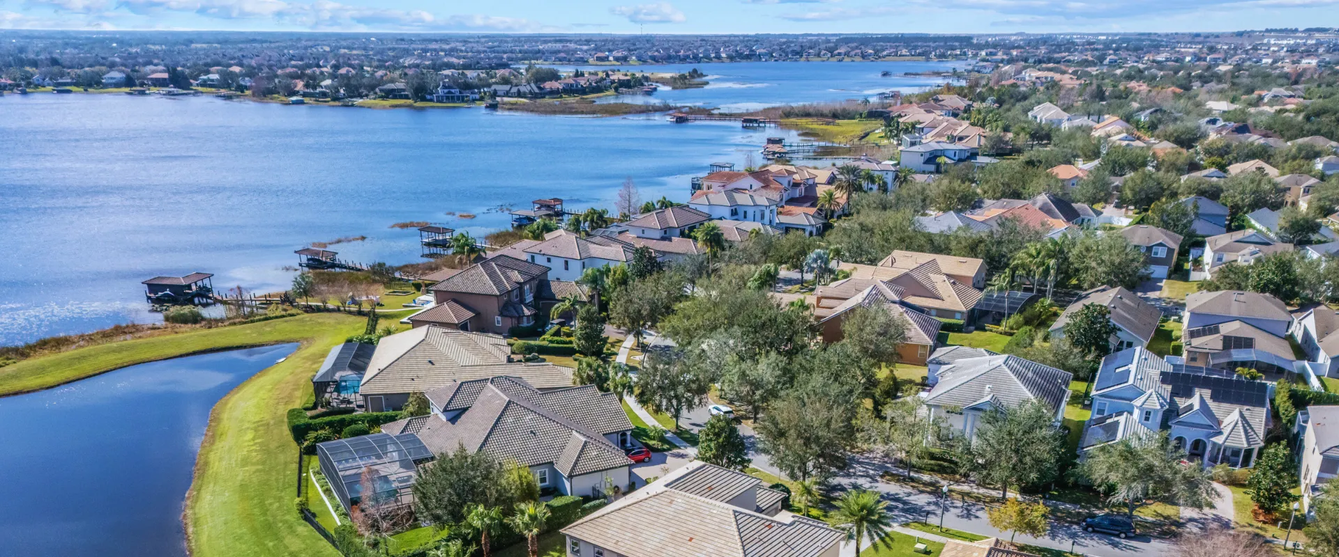 Aerial view of Horizon West real estate in Winter Garden, Florida, featuring waterfront homes, docks, and lush green spaces.